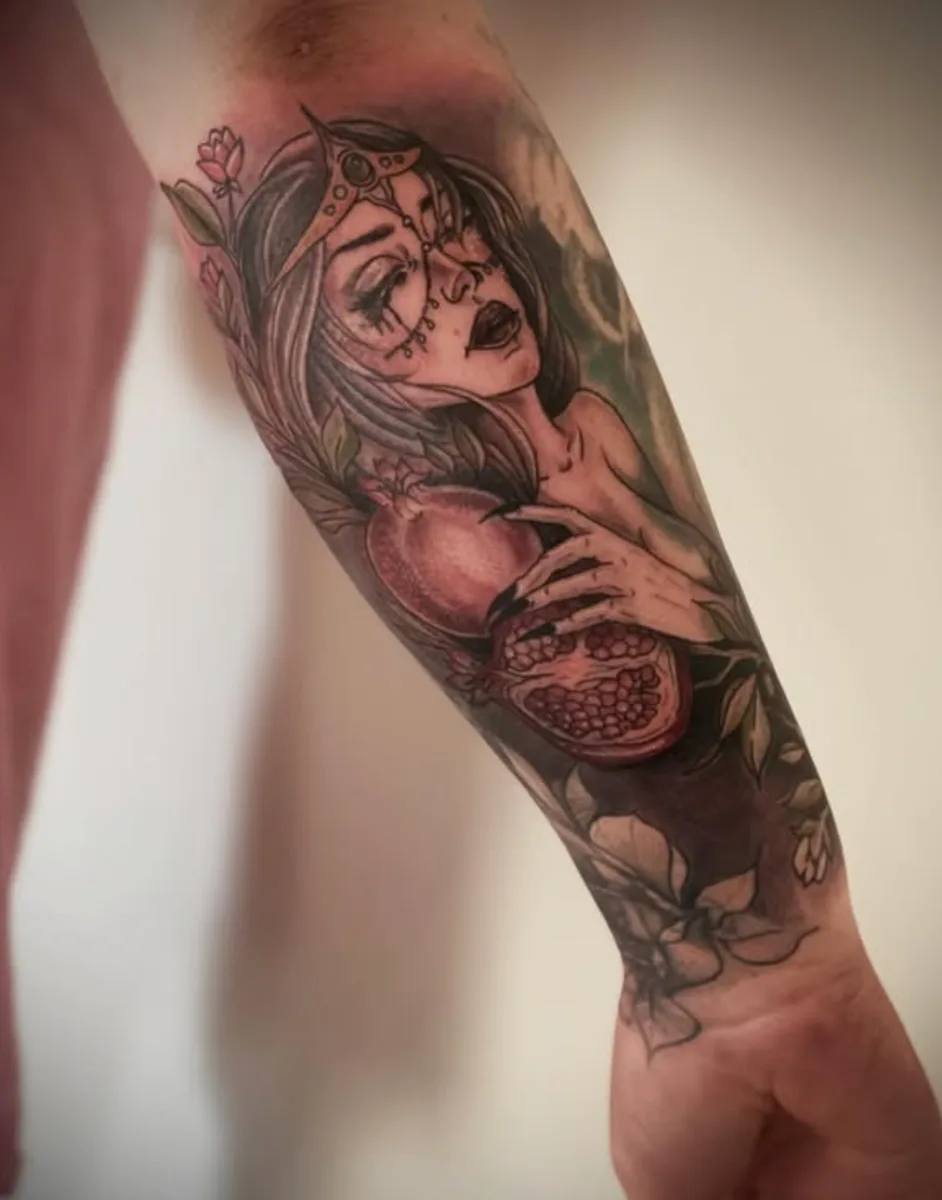 Neo traditional figure and pomegranate forearm tattoo by Abby Christ at True North Tattoo in Lancaster, PA