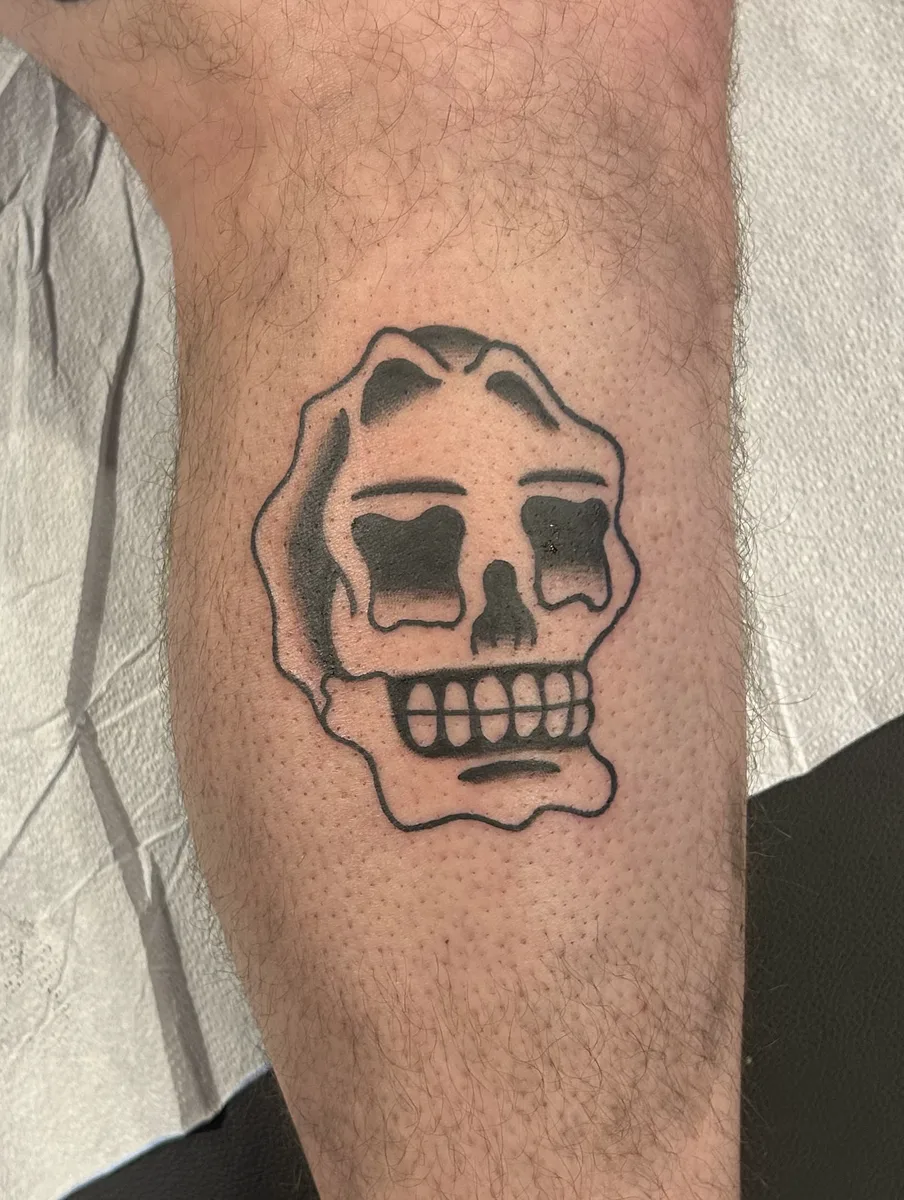 Traditional bold black skull tattoo on a leg by Joel at True North Tattoo in Lancaster, PA