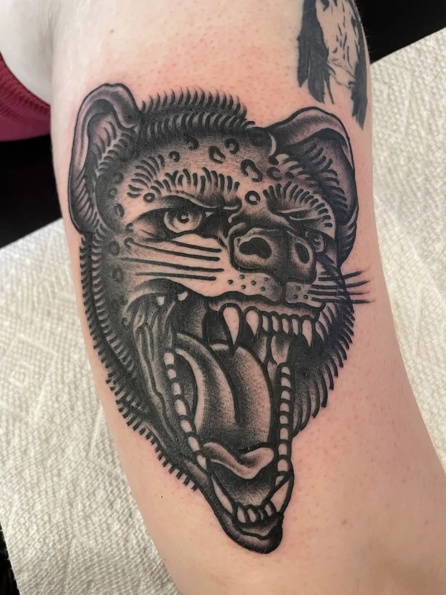 Black and grey illustrative animal skull with exposed ribcage and jaw, tattooed on an upper arm by Josh Espenschied at True North Tattoo in Lancaster, PA