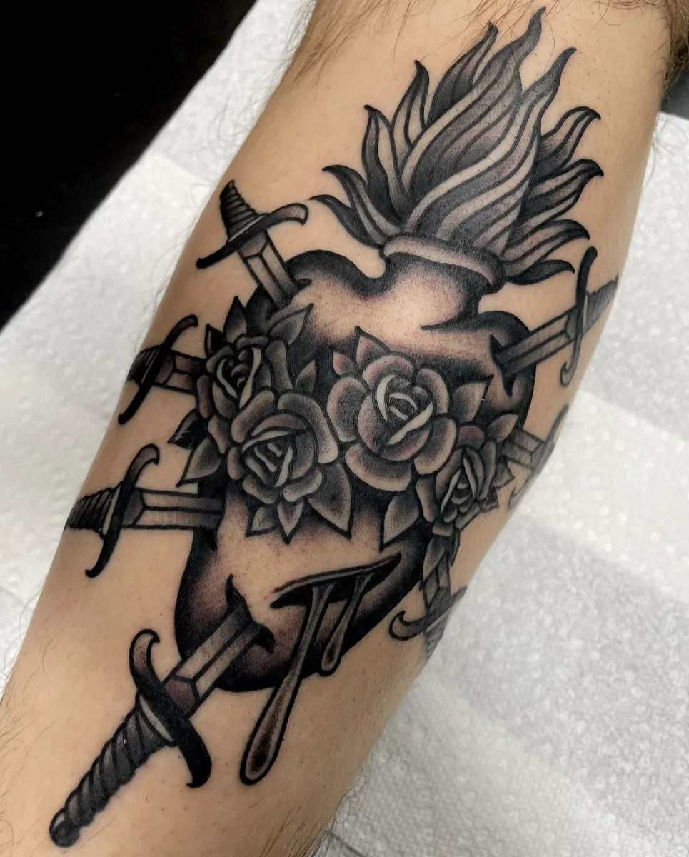 Traditional sacred heart pierced by five daggers and wrapped in roses, tattooed on a forearm by Josh Espenschied at True North Tattoo in Lancaster, PA