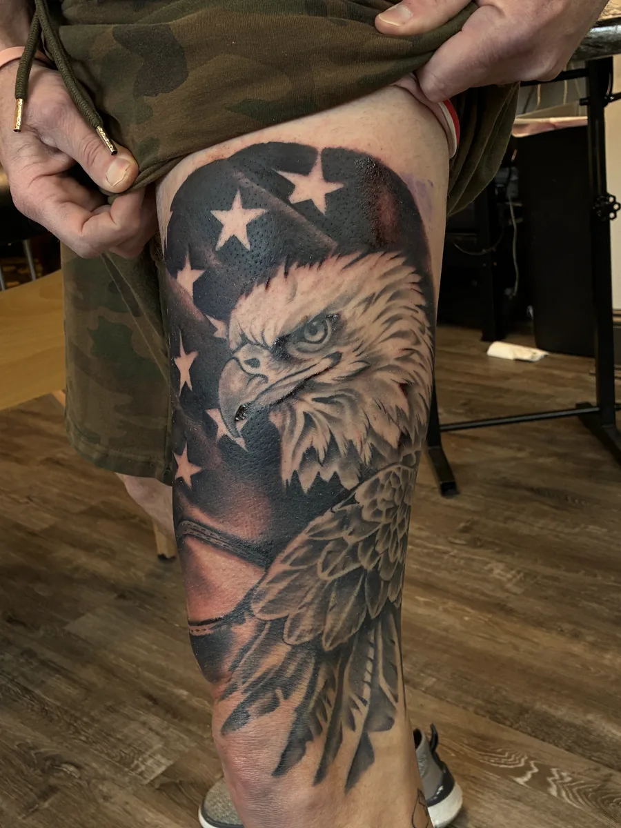 Black and grey bald eagle and American flag leg tattoo by Reed Drury at True North Tattoo in Lancaster, PA