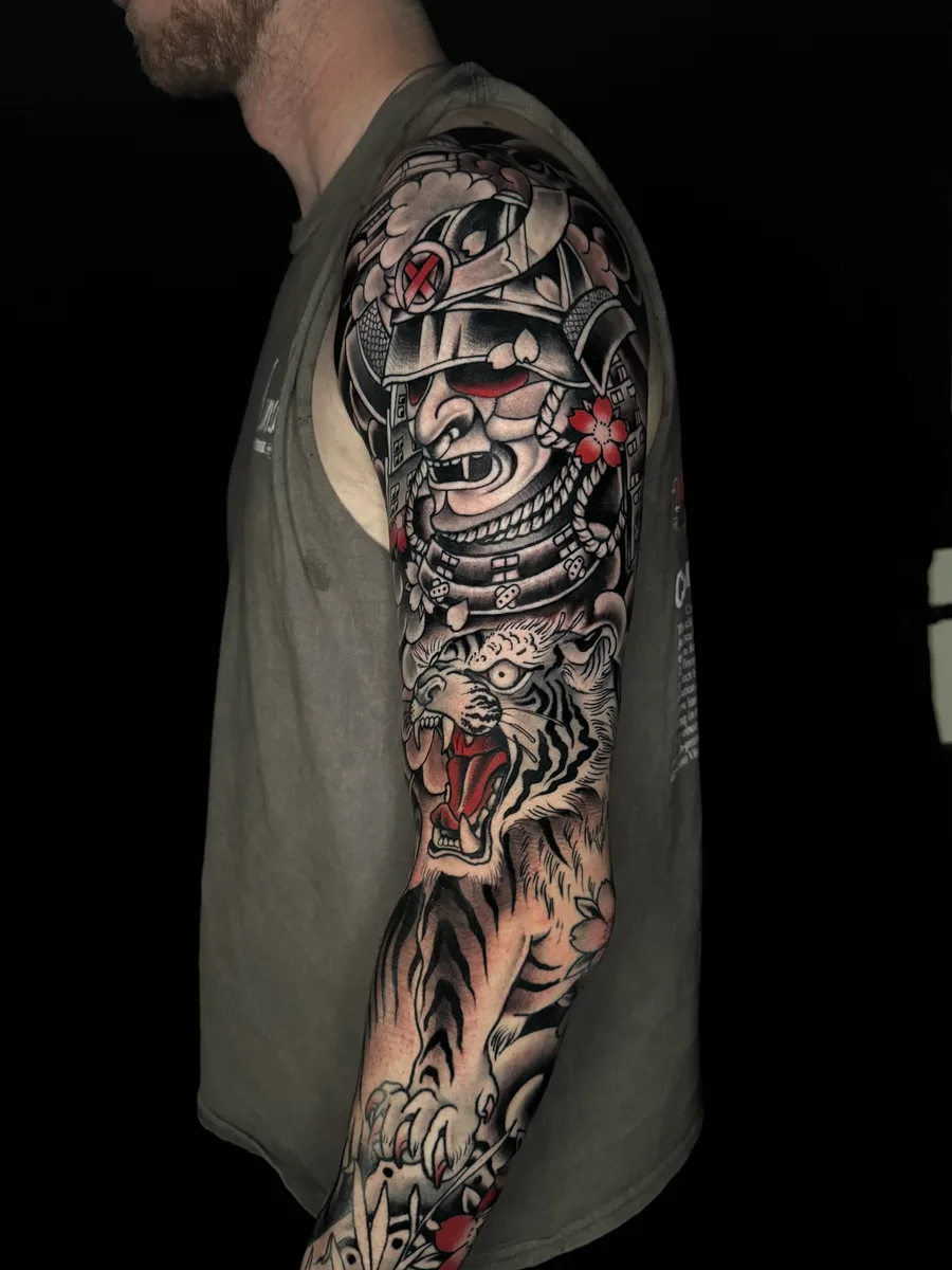 Japanese samurai mask and tiger full sleeve tattoo in black, grey and red by Reed Drury at True North Tattoo in Lancaster, PA