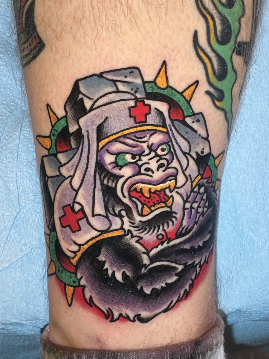 American traditional gorilla nurse tattoo in bold color on a lower leg by Reed Drury at True North Tattoo in Lancaster, PA